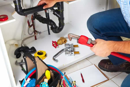 Technician using leak detection equipment in a Ventura, CA bathroom