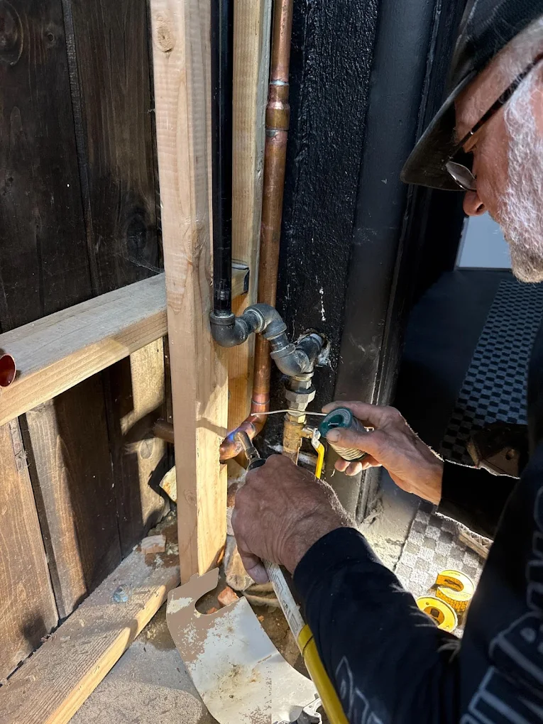 AAA Paradise Plumbing technician sweating a copper pipe repair in an exposed wall in Ventura, CA