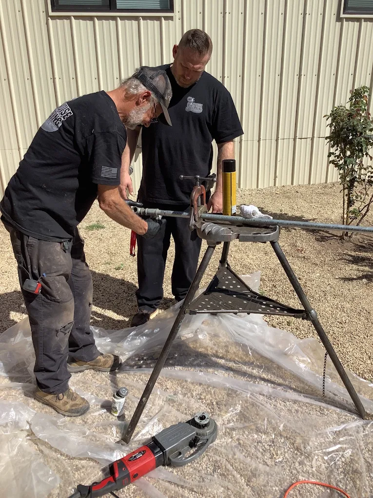 AAA Paradise Plumbing technicians threading black iron pipe for a gas line job in Ventura, CA