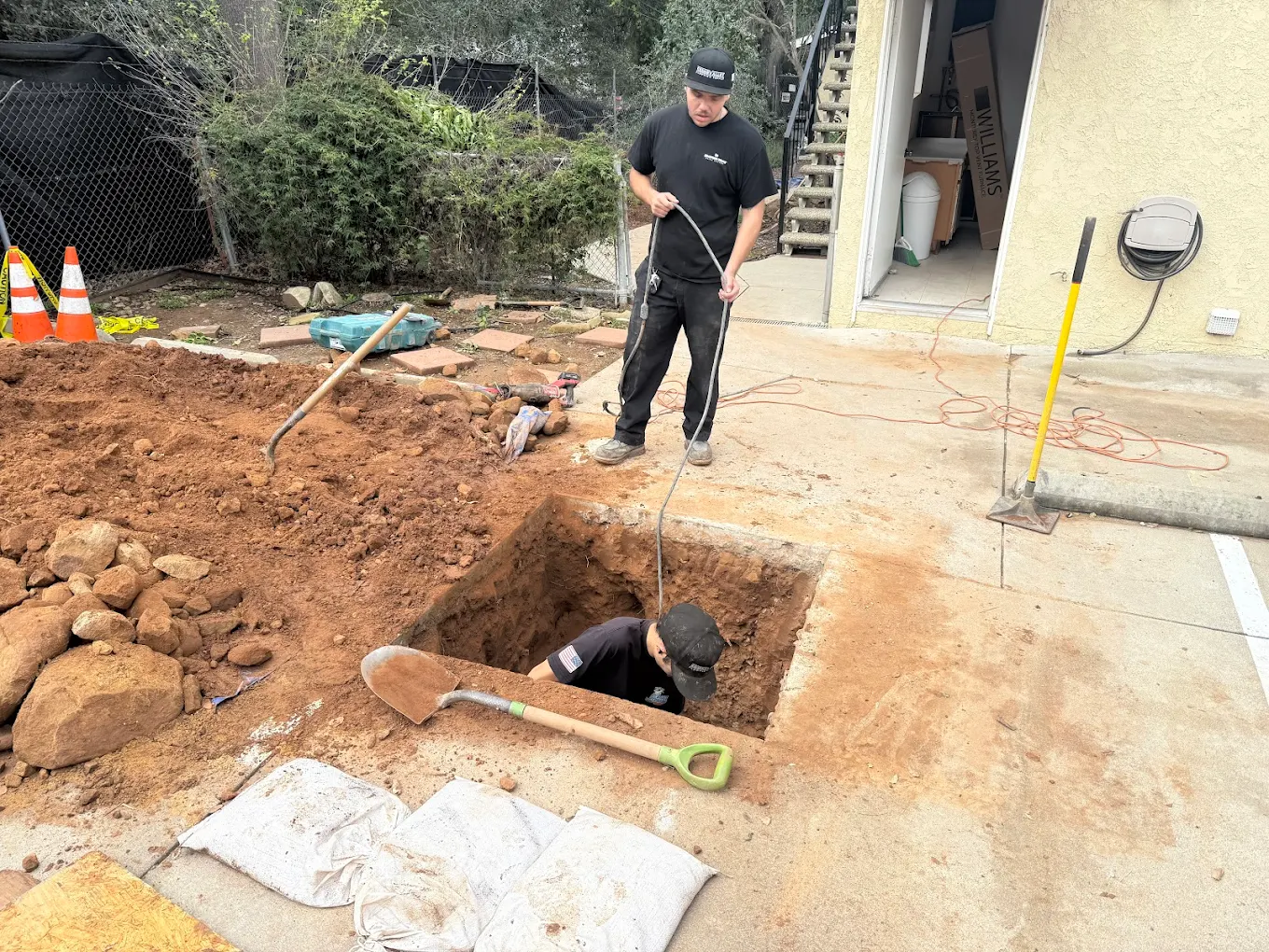 AAA Paradise Plumbing crew feeding a cable into a trenchless sewer access pit in Ventura, CA