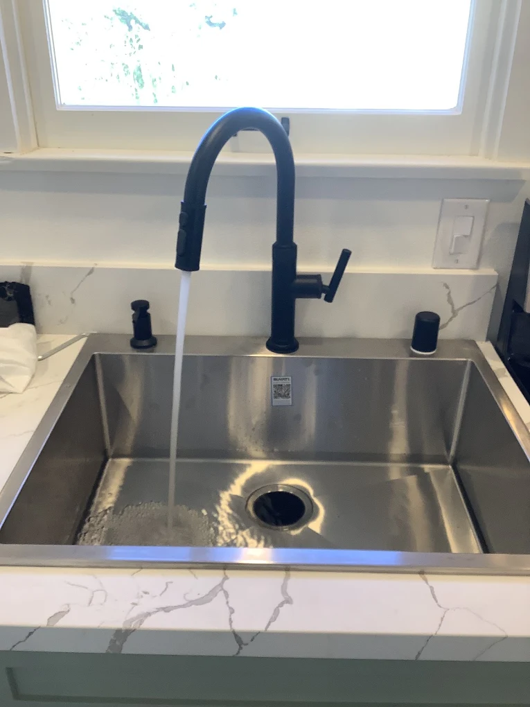 Clean filtered water flowing from a kitchen sink in a Ventura, CA home with a whole house filtration system